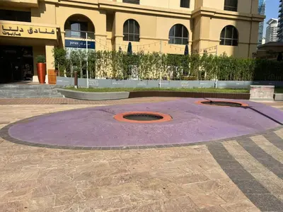 a purple circle in front of a building at 2BD apartment in Bahar JBR near beach in Dubai