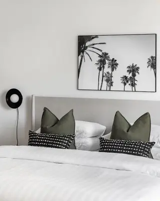 a bedroom with a bed with black and white pillows at Studio in Burj Views by Radiance Vacation Stays in Dubai