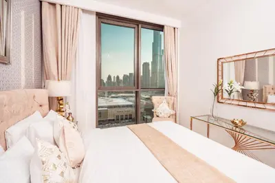 a bedroom with a bed and a large window at Elite Royal Apartment - Panoramic Full Burj Khalifa, Fountain & Skyline View - ACed direct connection to Dubai Mall - Governor in Dubai