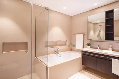 a bathroom with a tub and a glass shower at Elite Royal Apartment - Panoramic Full Burj Khalifa, Fountain & Skyline View - ACed direct connection to Dubai Mall - Governor in Dubai
