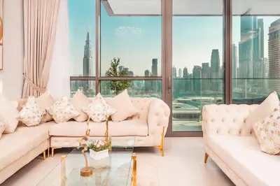 a living room with two couches and a large window at Elite Royal Apartment - Panoramic Full Burj Khalifa, Fountain & Skyline View - ACed direct connection to Dubai Mall - Governor in Dubai
