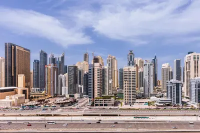 a large city with a highway and many tall buildings at 180° Sheik Zayed Road balcony views 2BR in JLT in Dubai