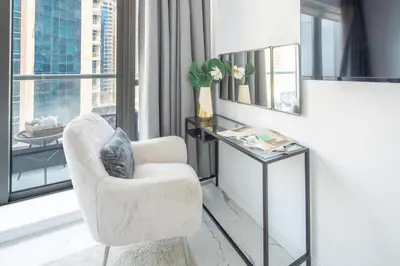 a living room with a chair and a table at Frank Porter - The Point in Dubai