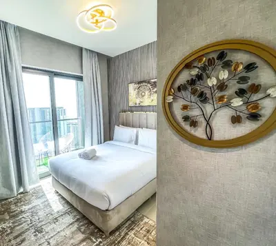 a bedroom with a bed and a painting on the wall at STAY BY LATINEM Luxury 2BR Holiday Home CV B2513 near Burj Khalifa in Dubai