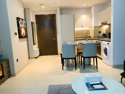 a kitchen with a table and chairs in a room at STAY BY LATINEM Luxury 2BR Holiday Home CV B2513 near Burj Khalifa in Dubai