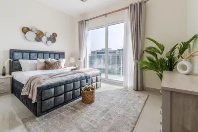 a bedroom with a large bed and a large window at GuestReady - Stylish Apt in Business Bay in Dubai