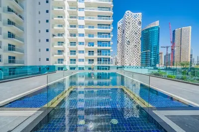 a swimming pool in a city with tall buildings at GuestReady - Stylish Apt in Business Bay in Dubai