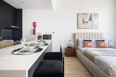 a bedroom with a bed and a counter with a table at Frank Porter - Regina Tower in Dubai