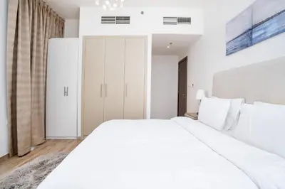 a white bedroom with a large white bed at White Sage - Amna Tower in Dubai