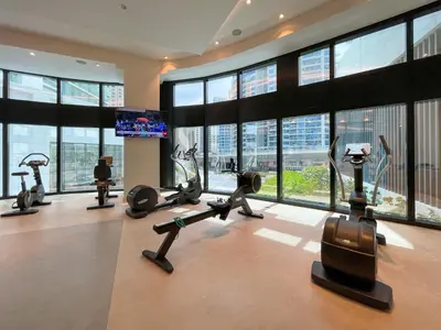a gym with treadmills and exercise bikes in a building at 72 floor 2BR at the Address JBR with Marina Views! in Dubai