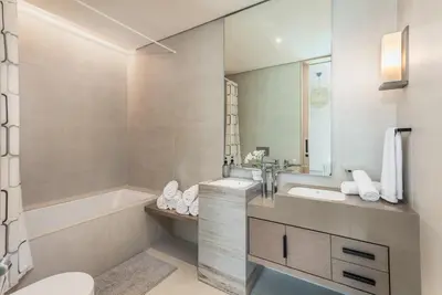a bathroom with a tub and a sink and a toilet at 72 floor 2BR at the Address JBR with Marina Views! in Dubai