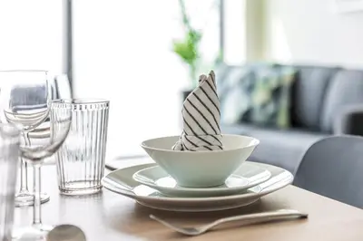 a bowl of food on a table with wine glasses at 72 floor 2BR at the Address JBR with Marina Views! in Dubai