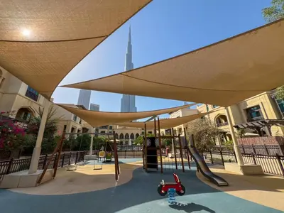 a playground with a slide and a swing set at Durrani Homes - Heaven on Earth in Dubai