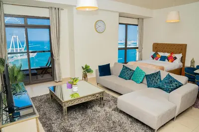 a living room with a couch and a table at Luxury Casa - Platinum Sea View Apartment 2BR at JBR Beach in Dubai