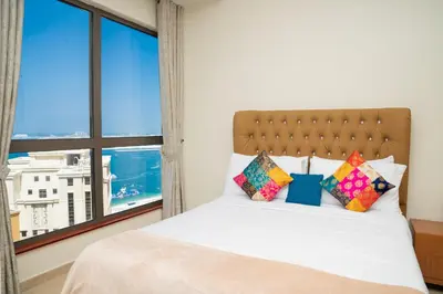 a bedroom with a bed with a large window at Luxury Casa - Platinum Sea View Apartment 2BR at JBR Beach in Dubai