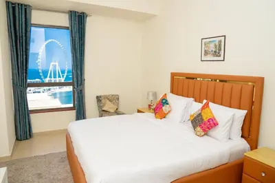 a bedroom with a bed with a view of the wheel at Luxury Casa - Platinum Sea View Apartment 2BR at JBR Beach in Dubai
