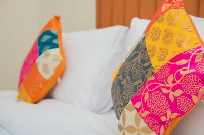 two pillows sitting on top of a bed at Luxury Casa - Platinum Sea View Apartment 2BR at JBR Beach in Dubai