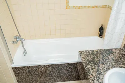 a bathroom with a white tub and a sink at Luxury Casa - Platinum Sea View Apartment 2BR at JBR Beach in Dubai