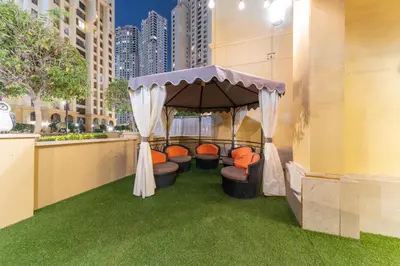 a gazebo with orange chairs in a building at Elan Suites 5-Bedroom Beach Villa in Dubai