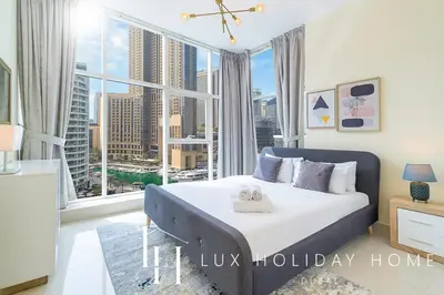a bedroom with a bed and a large window at LUX Marina View Prime Location Near Beach in Dubai
