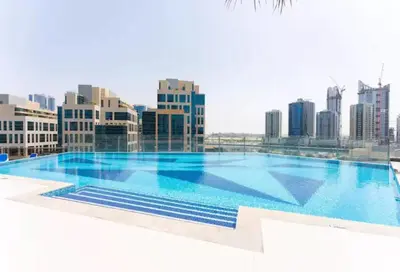 a large swimming pool on top of a city at Luxury Burj Khalifa View Studio Elite Downtown - 18AB19AB03 in Dubai