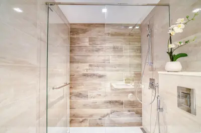 a shower stall with a glass door in a bathroom at Studio with City Views, Jumeirah Lake Towers - Mint Stay in Dubai