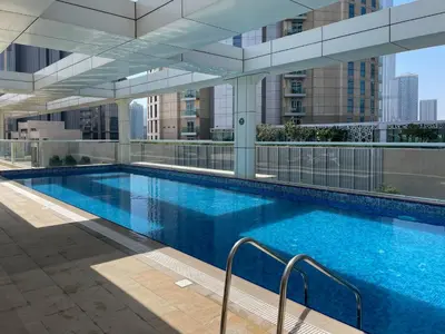 a large swimming pool on top of a building at Beautiful & Bright 2BR + kids - 7min to Dubai Mall in Dubai