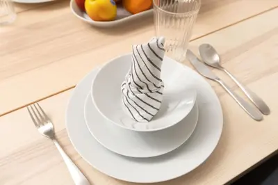 a white plate with a dessert in a bowl on a table at Beautiful & Bright 2BR + kids - 7min to Dubai Mall in Dubai