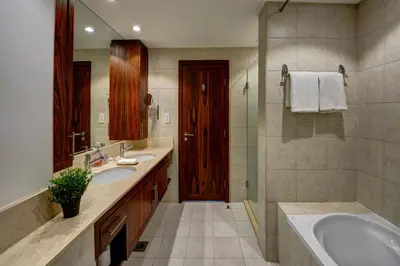 a bathroom with two sinks and a tub and a mirror at Durrani Homes - Luxe Living with Burj Khalifa and Fountain View - third room without partition in Dubai