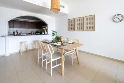 a kitchen and dining room with a table and chairs at Frank Porter - Grand Horizon in Dubai