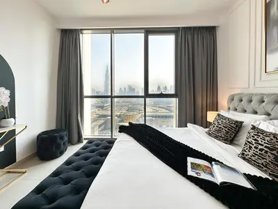 a bedroom with a large bed with a large window at Stylish 2 Bedroom Dior-Inspired Apartment Connected to Dubai Mall in Dubai