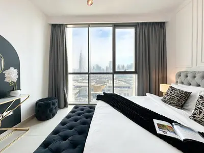 a bedroom with a large bed with a large window at Stylish 2 Bedroom Dior-Inspired Apartment Connected to Dubai Mall in Dubai