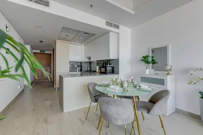 a kitchen and dining room with a table and chairs at GlobalStay Azizi Mina Beachfront Apartments Palm Jumeirah in Dubai