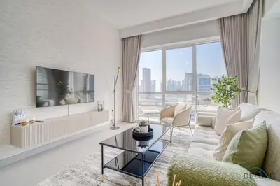 a living room with a couch and a tv at Deal of the Week Stylish 1BR with Partial Burj Views by Deluxe Holiday Homes in Dubai