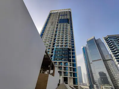 a tall building in a city with tall buildings at HiGuests - Roomy and Chic Studio with Panoramic Canal Views in Dubai