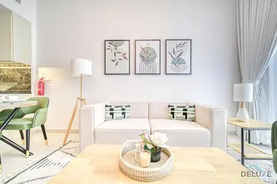 a living room with a couch and a table at Prime 1BR at Binghatti Avenue Al Jaddaf by Deluxe Holiday Homes in Dubai