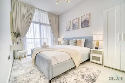 a bedroom with a bed and a large window at Prime 1BR at Binghatti Avenue Al Jaddaf by Deluxe Holiday Homes in Dubai