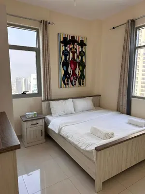 a bedroom with a bed and a painting on the wall at Dubai Marina Royal Premium Serviced Apartments Marina Wharf - KIDS STAY FREE plus free check in 24 hours in Dubai