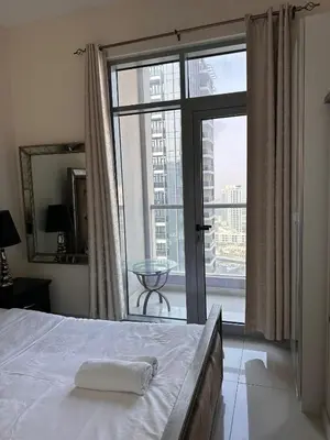 a bedroom with a bed and a large window at Dubai Marina Royal Premium Serviced Apartments Marina Wharf - KIDS STAY FREE plus free check in 24 hours in Dubai