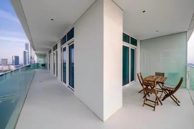 a balcony with a table and chairs on a building at Breathtaking Atlantis view, Spacious 2BR on beach in Dubai