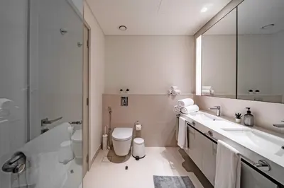 a bathroom with a sink and a toilet and a shower at Breathtaking Atlantis view, Spacious 2BR on beach in Dubai