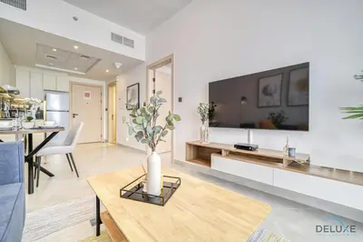 a living room with a tv and a table at Harmonious 1BR at Binghatti Avenue Al Jaddaf by Deluxe Holiday Homes in Dubai