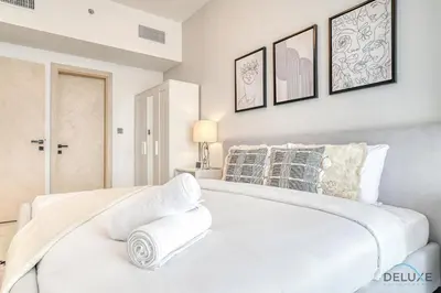a white bedroom with a large white bed at Harmonious 1BR at Binghatti Avenue Al Jaddaf by Deluxe Holiday Homes in Dubai