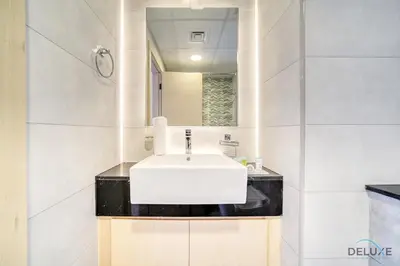 a bathroom with a white sink and a mirror at Harmonious 1BR at Binghatti Avenue Al Jaddaf by Deluxe Holiday Homes in Dubai