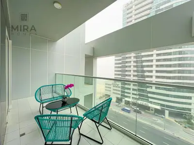 a balcony with two chairs and a table in a building at Mira Holiday Homes - Newly furnished 1 bedroom in Business Bay in Dubai