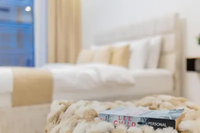 a book sitting on top of a table in a living room at The Smart Concierge - Waves by Kasco in Dubai