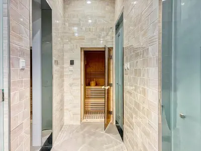 a hallway with a tile wall and a door at The Smart Concierge - Waves by Kasco in Dubai