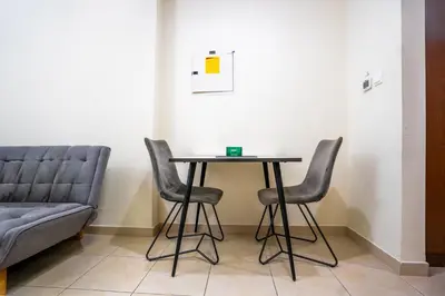 a table and chairs in a room with a couch at RH- Contemporary Studio, Downtown, Near Dubai Mall & Burj Khalifa in Dubai