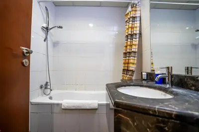 a bathroom with a sink and a bath tub at RH- Contemporary Studio, Downtown, Near Dubai Mall & Burj Khalifa in Dubai