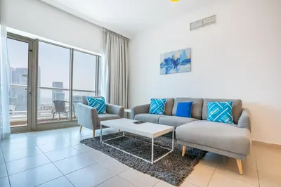 a living room with a couch and a table at RH- Modern Elegance 2BR, prime location, Walk to Dubai Mall in Dubai